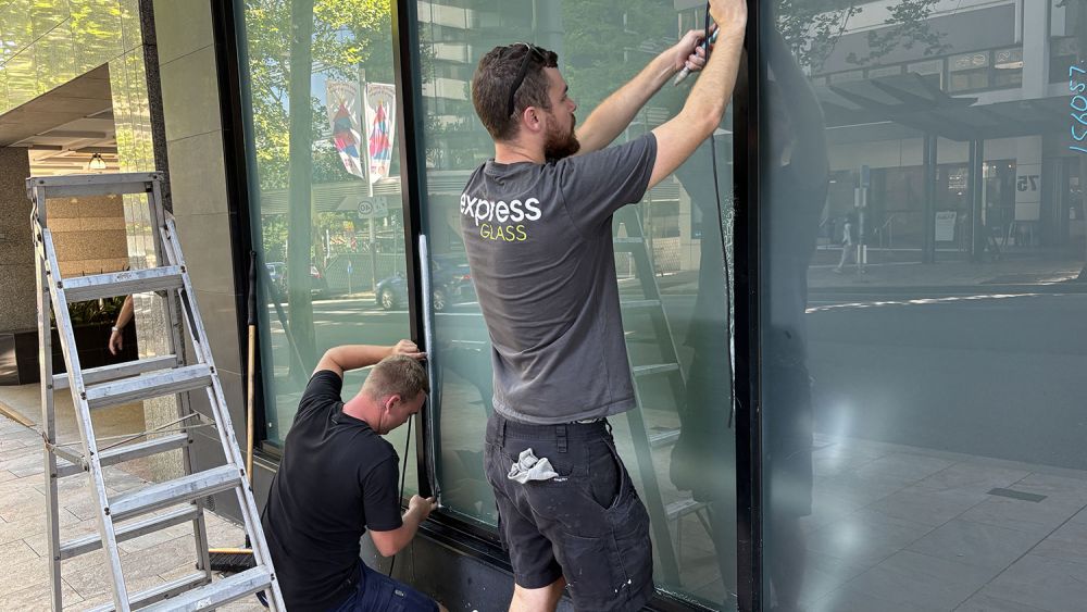 A rapid response Express Glass crew performing an emergency glass repair service in [state]